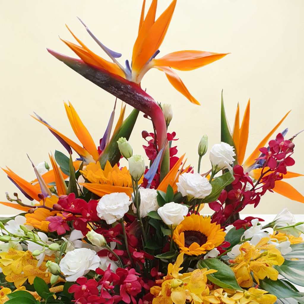 Serene Blossoms bird of paradise, sunflower and orchid table arrangement for birthday or anniversary with delivery in Kuala Lumpur and Selangor