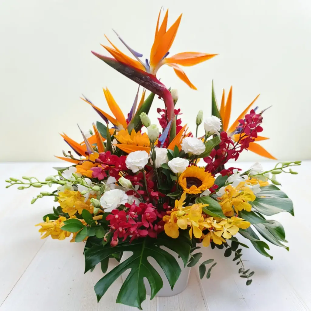 Serene Blossoms bird of paradise, sunflower and orchid table arrangement for birthday or anniversary with delivery in Kuala Lumpur and Selangor