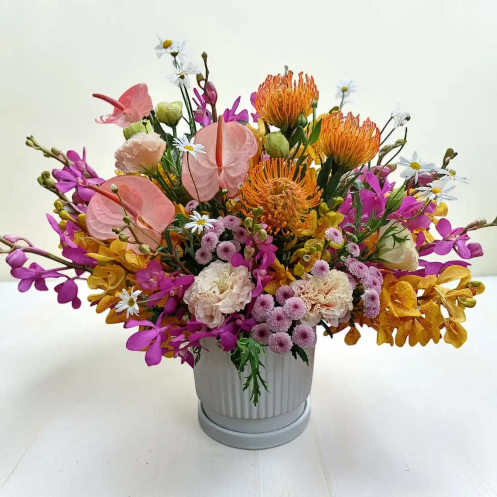 Tranquil Petals pin cushion protea and orchid table arrangement for birthday or anniversary with delivery in Kuala Lumpur and Selangor