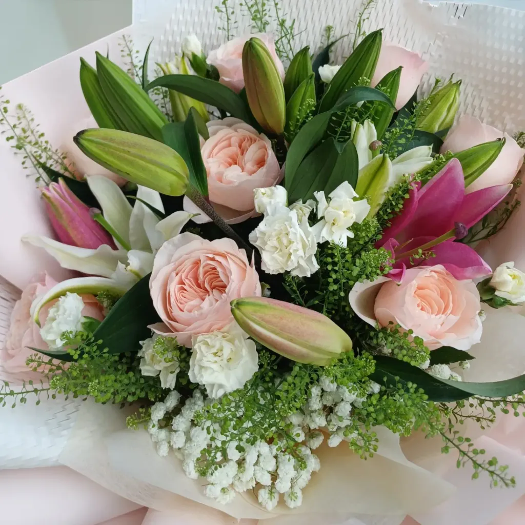 Blooming Treasure lilies, roses, spray carnations hand bouquet for Mother's Day, birthday and anniversary with delivery in Kuala Lumpur and Selangor