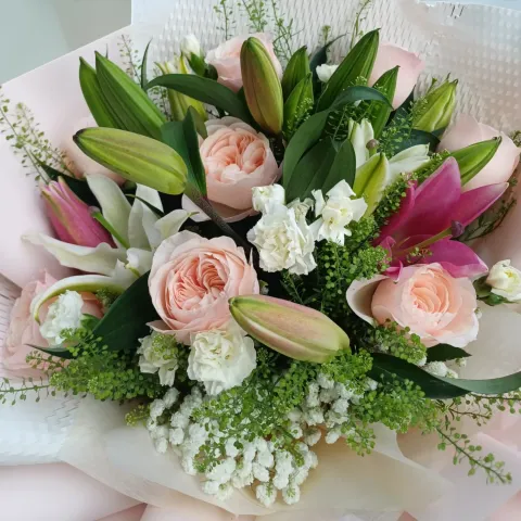Blooming Treasure lilies, roses, spray carnations hand bouquet for Mother's Day, birthday and anniversary with delivery in Kuala Lumpur and Selangor
