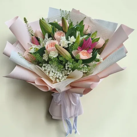 Blooming Treasure lilies, roses, spray carnations hand bouquet for Mother's Day, birthday and anniversary with delivery in Kuala Lumpur and Selangor