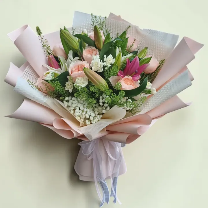 Blooming Treasure lilies, roses, spray carnations hand bouquet for Mother's Day, birthday and anniversary with delivery in Kuala Lumpur and Selangor