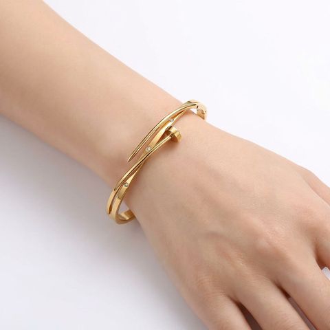 gemini-image-2_45-degree_angle_with_model_hand_Prompt_A_high-end_product_shot_of_the_gold_bangl-0