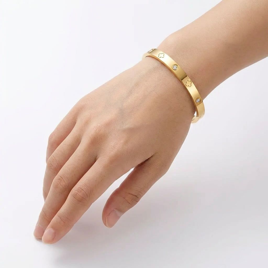 gemini-image-2_First_Photo_with_model_hand_Prompt_Close-up_shot_of_a_golden_bracelet_with_flora-0