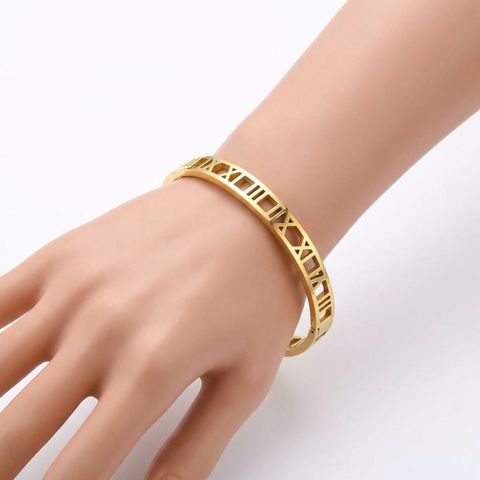 gemini-image-2_First_Photo_with_model_hand_Prompt_Close-up_shot_of_a_gold_bracelet_with_geometr-0