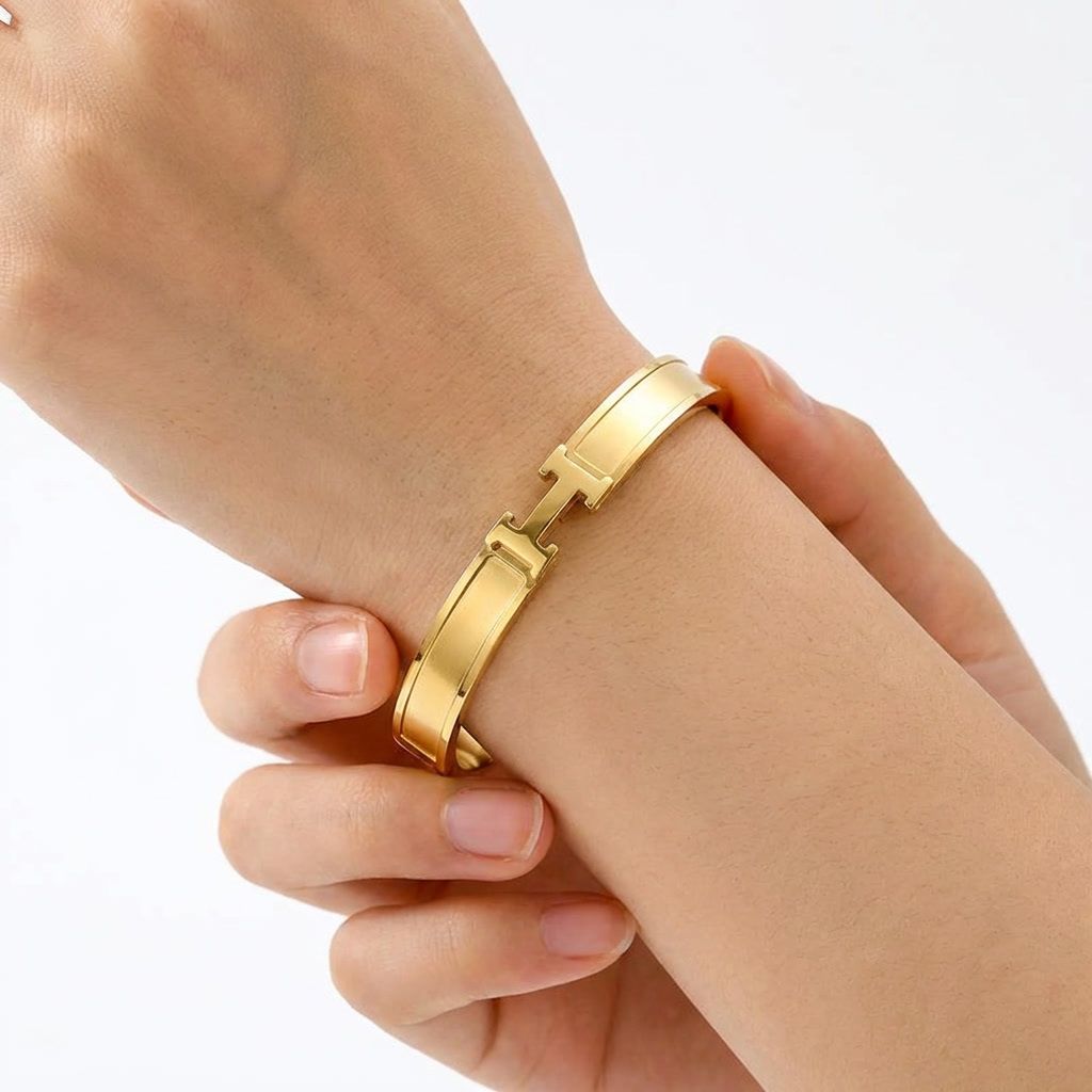 gemini-image-2_First_Photo_worn_on_model_s_hand_Prompt_Close-up_shot_of_a_gold_bangle_worn_on_a-0