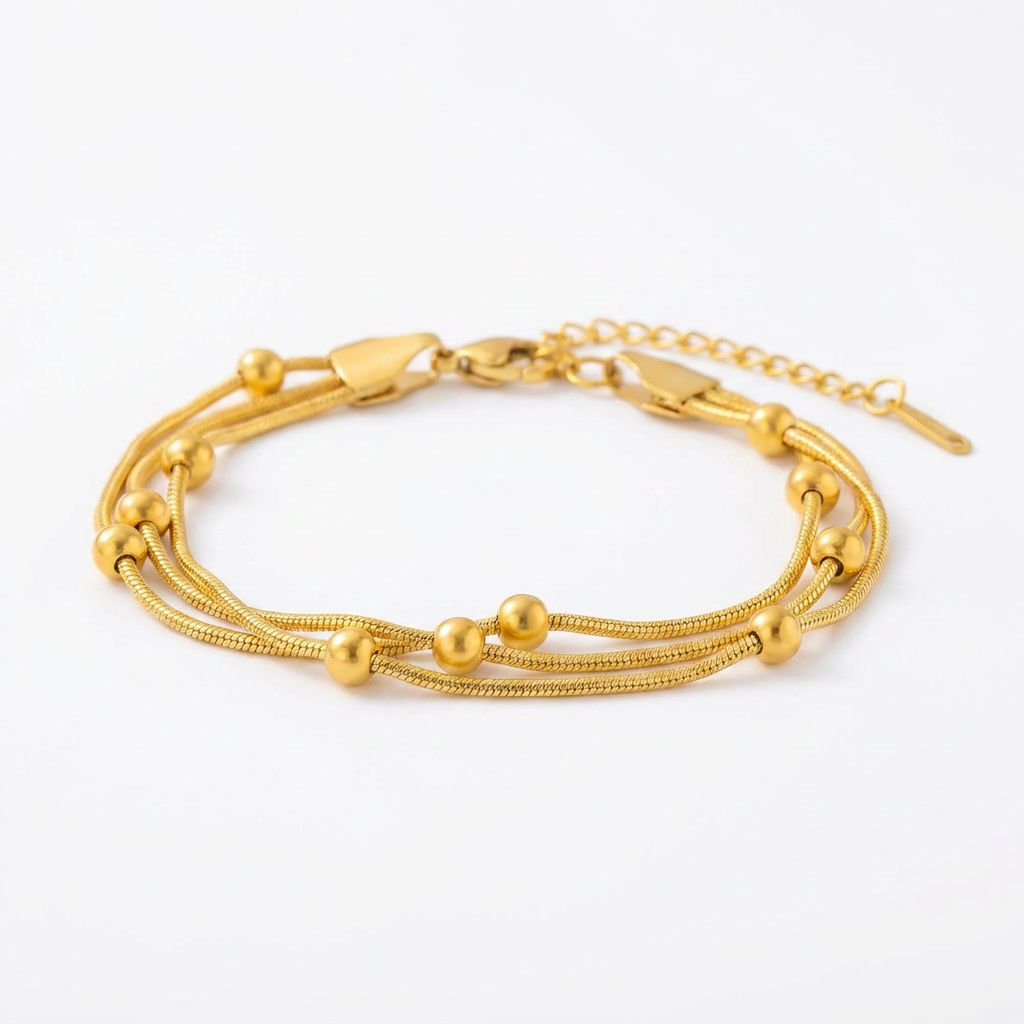 gemini-image-2_Prompt_A_side_angle_shot_of_the_gold_multi-strand_bracelet_placed_on_a_pure_whit-0