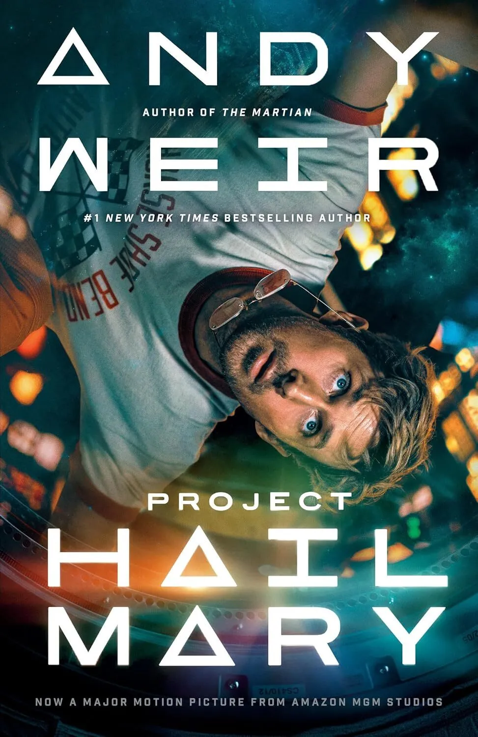 Front cover of Project Hail Mary by Andy Weir showing a sleek spacecraft against a vibrant yellow and black celestial background.