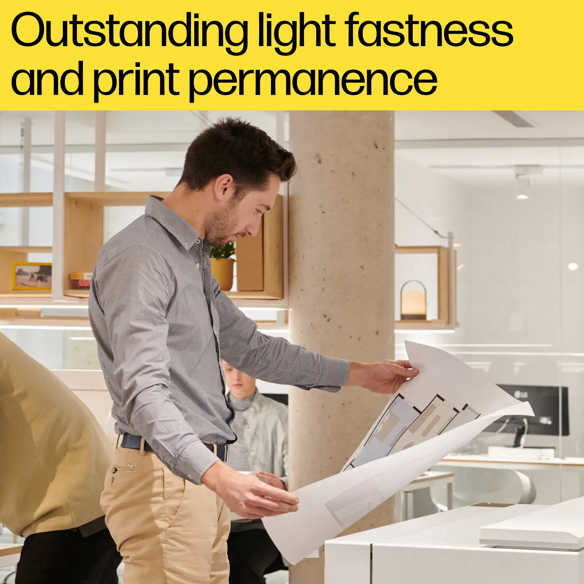A person examining a large-format print showing outstanding light fastness and print permanence, a key feature of the HP Flex Tech Inks.
