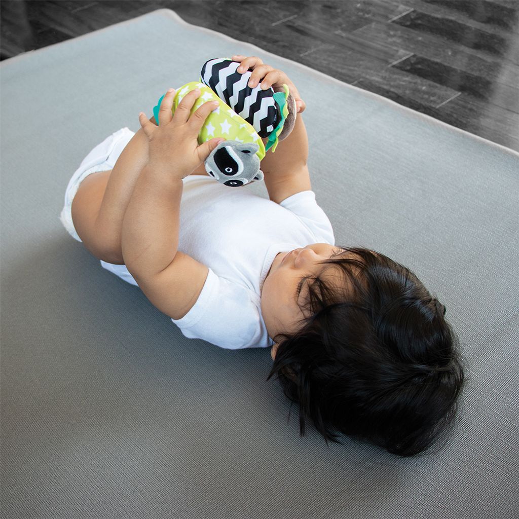 B0141_-_DUO_-_Lifestyle_-_Raccoon_and_Hedgehog_-_Focus_Baby_lying_on_couch_holding_feet_wearing_socks_-_Square_Format