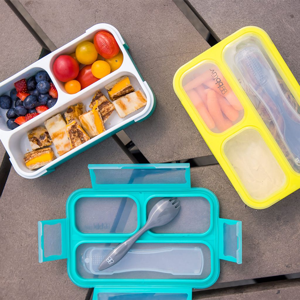 B0123_-_Bento_-_Lifestyle_-_Blue_Lunchbox_opened_-_Lid_and_Fork_on_side_-_Green_lunchbox_closed_-_Landscape_Format