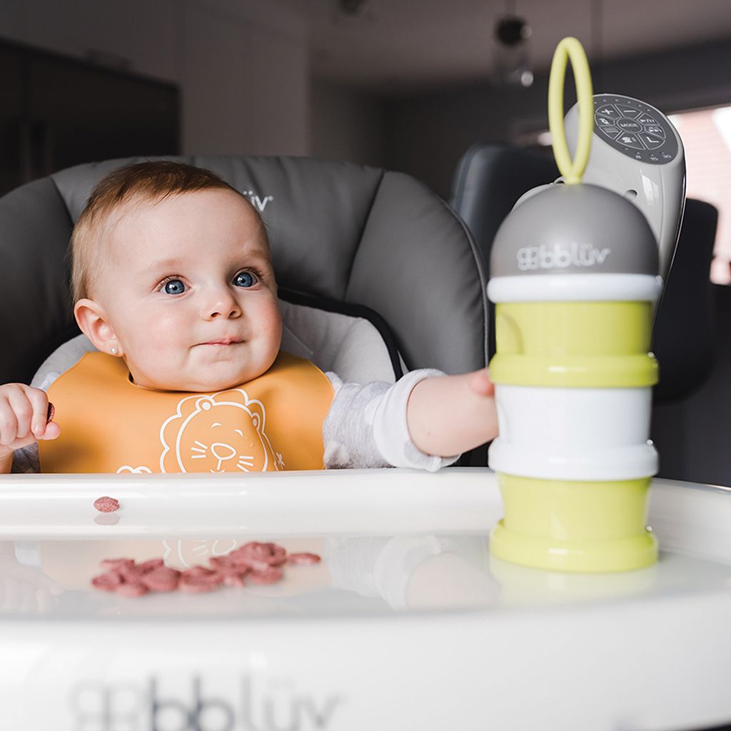 B0115_-_Dose_-_Lifestyle_-_Focus_on_Child_looking_up_while_pointed_piled_containers_sitting_on_kitchen_chair_-_Square_Format