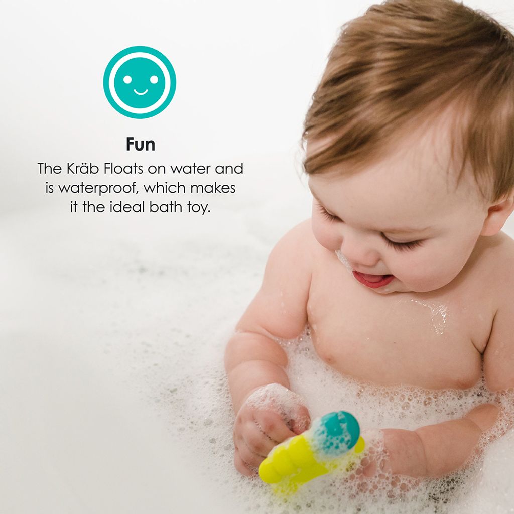 B0146_-_KRAB_-_Feature_-_Baby_holding_thermometer_in_bath_laughing