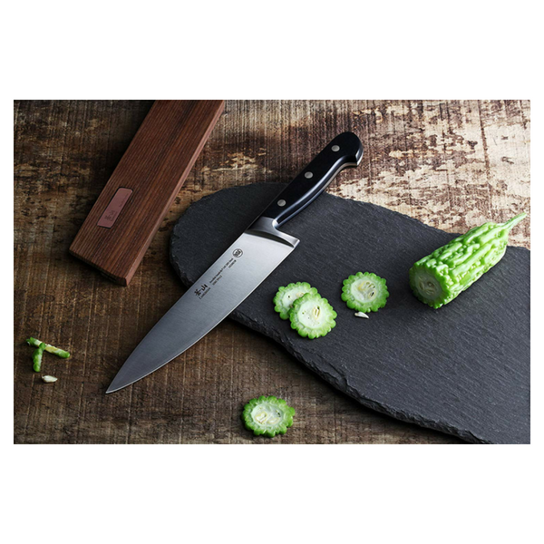 chefs knife on cutting board.png