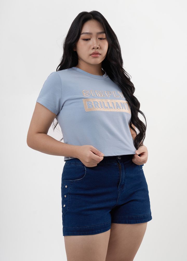 Plus-size blue graphic tee with “SIMPLY BRILLIANT” embroidered lettering.