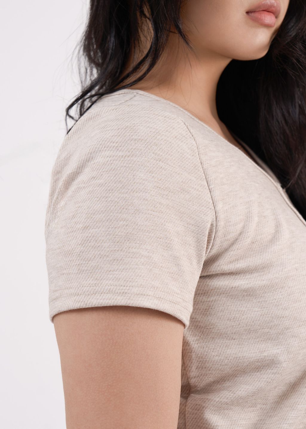 Short-sleeve beige bolero-style cardigan paired with a matching inner top.