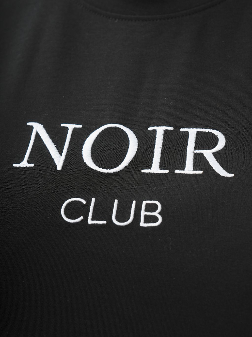 Black plus-size graphic tee paired with white pleated skort for contrast.