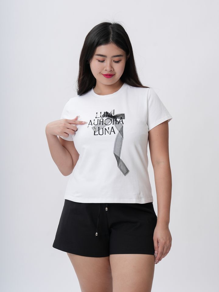 Plus-size white graphic tee with artistic black text and sheer ribbon accent.