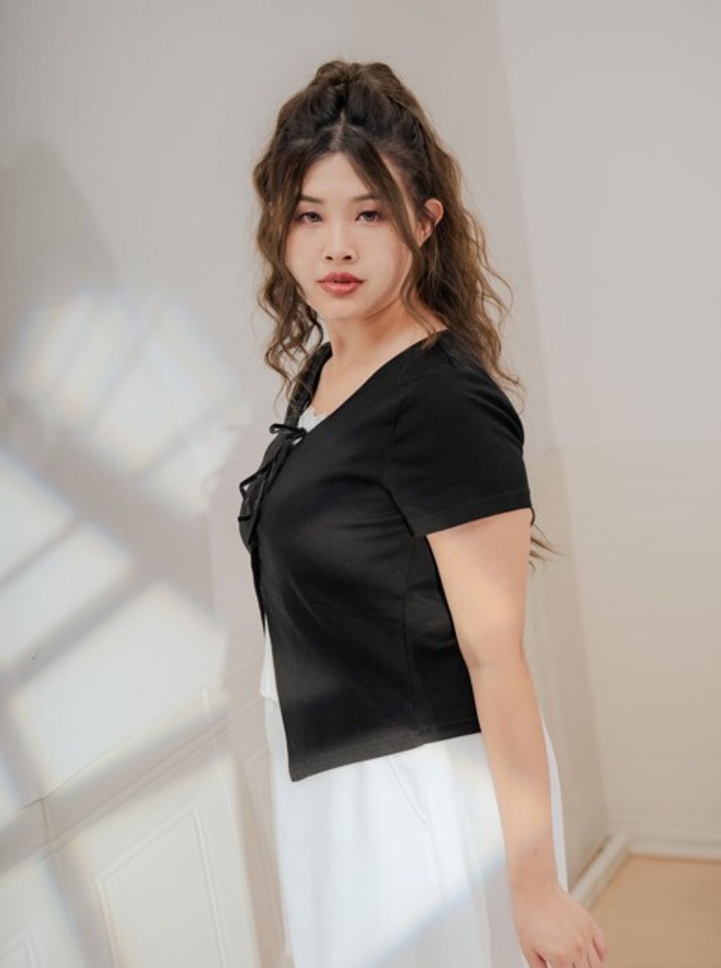 Sophisticated black top for plus-size women, ideal for chic night looks.