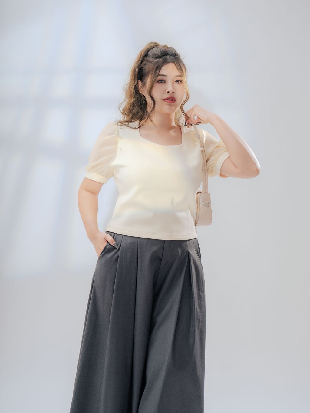 Elegant plus-size top with pearl accents and puff sleeves – perfect for chic occasions.