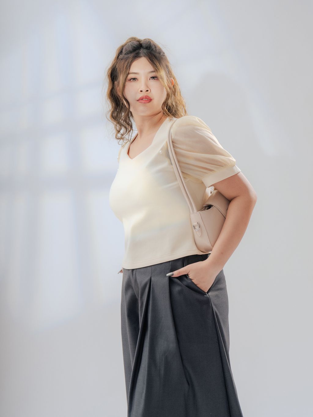 Plus-size feminine top featuring dreamy puff sleeves and a touch of pearl elegance.