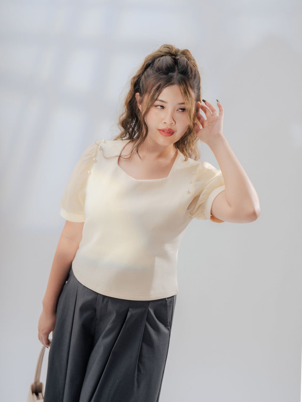 Ethereal puff-sleeve blouse designed to flatter curves with delicate pearl embellishment.