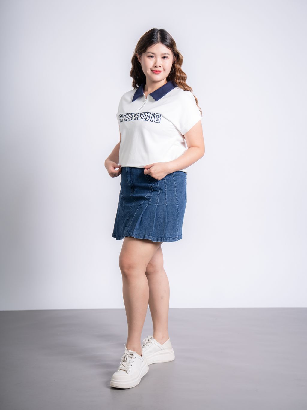 Modern plus size polo tee with front zip and structured cut for a slimming silhouette.