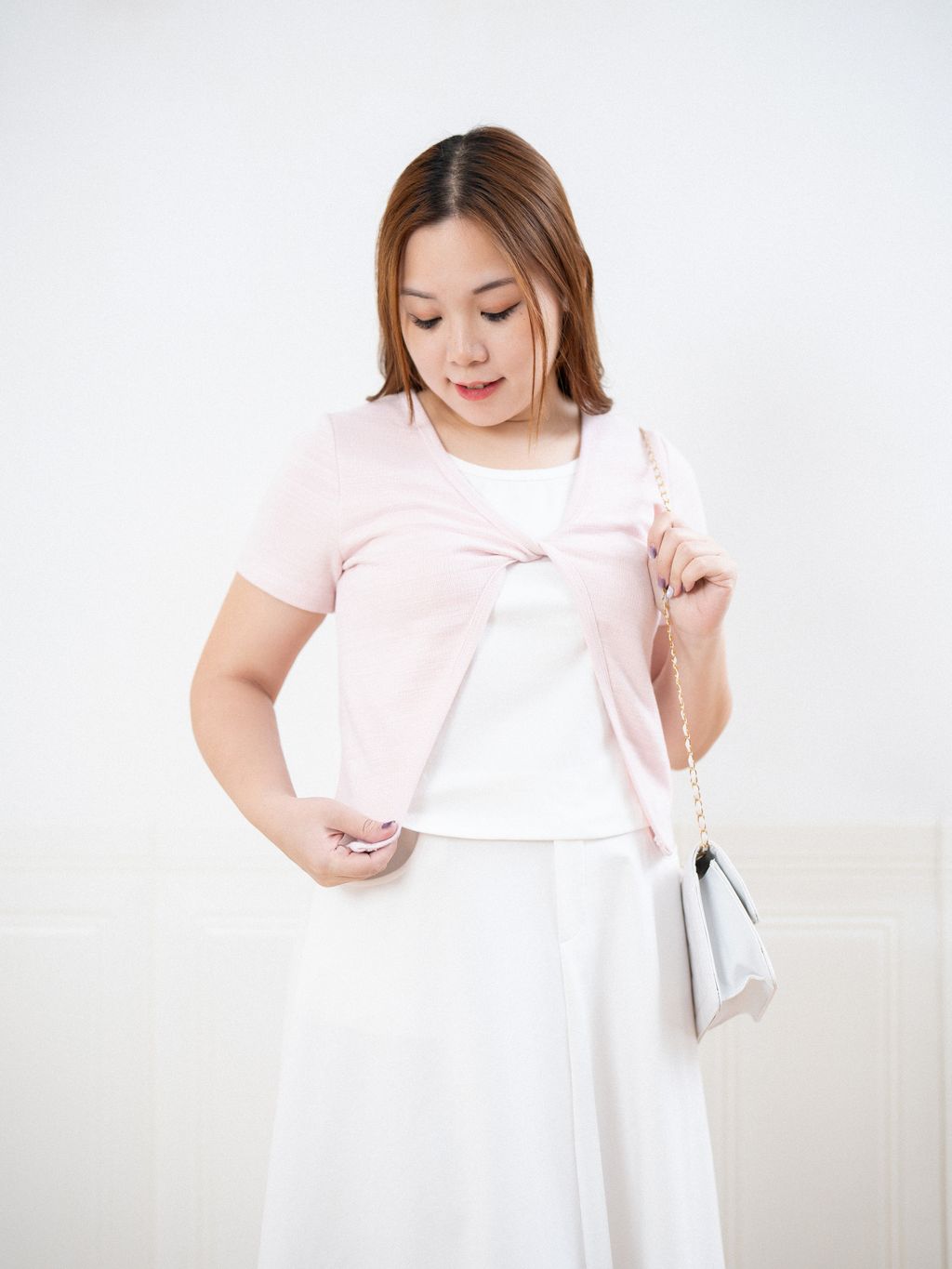 Soft breathable knit cardigan for plus size women with flattering front twist.