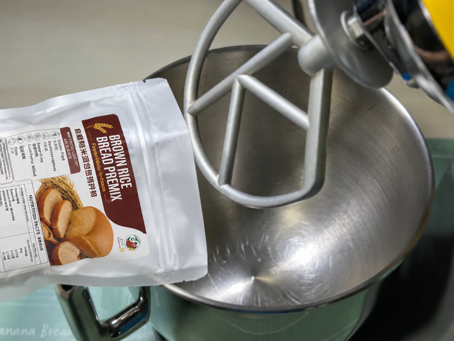 Brown rice bread premix pouring into mixer