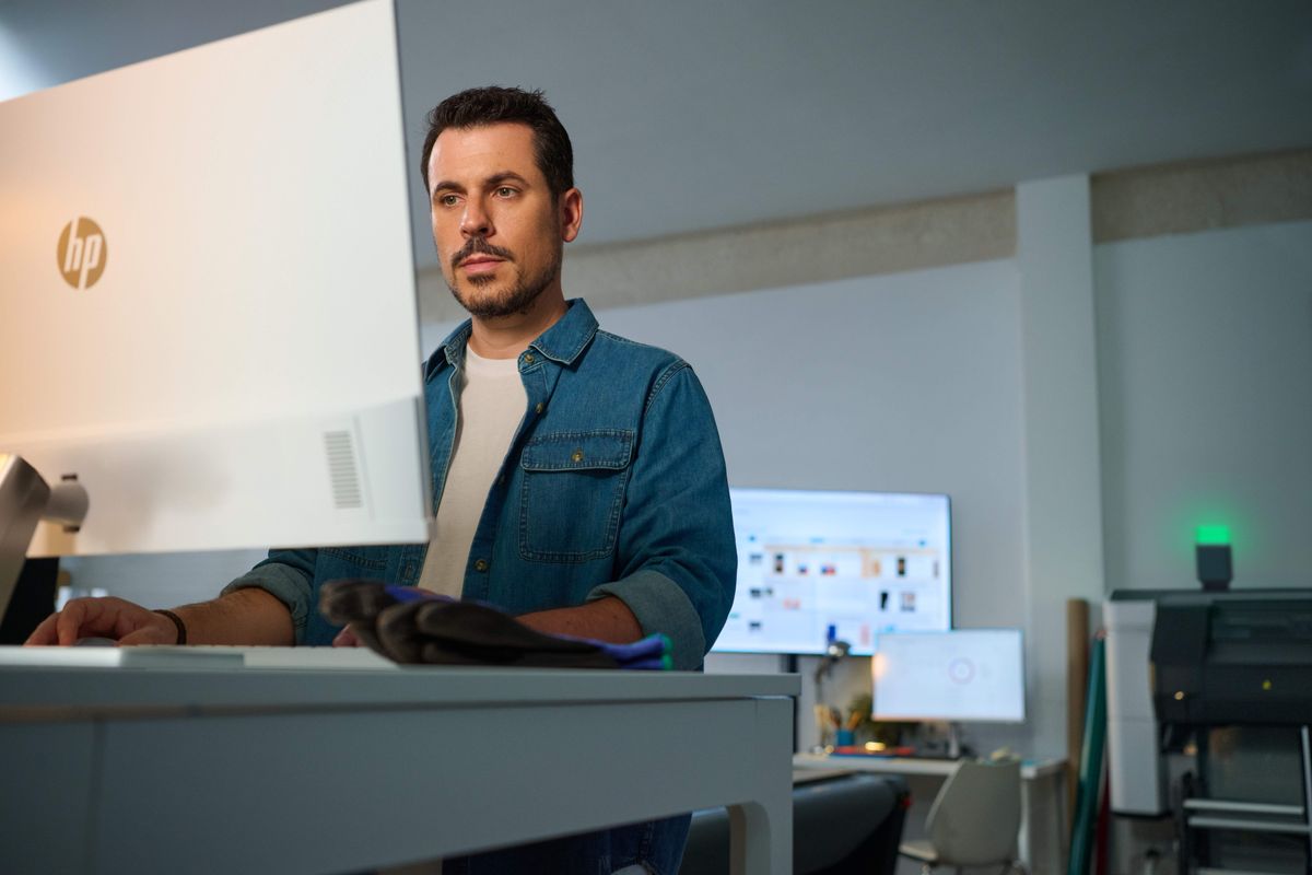 Technician working at an HP large format printer