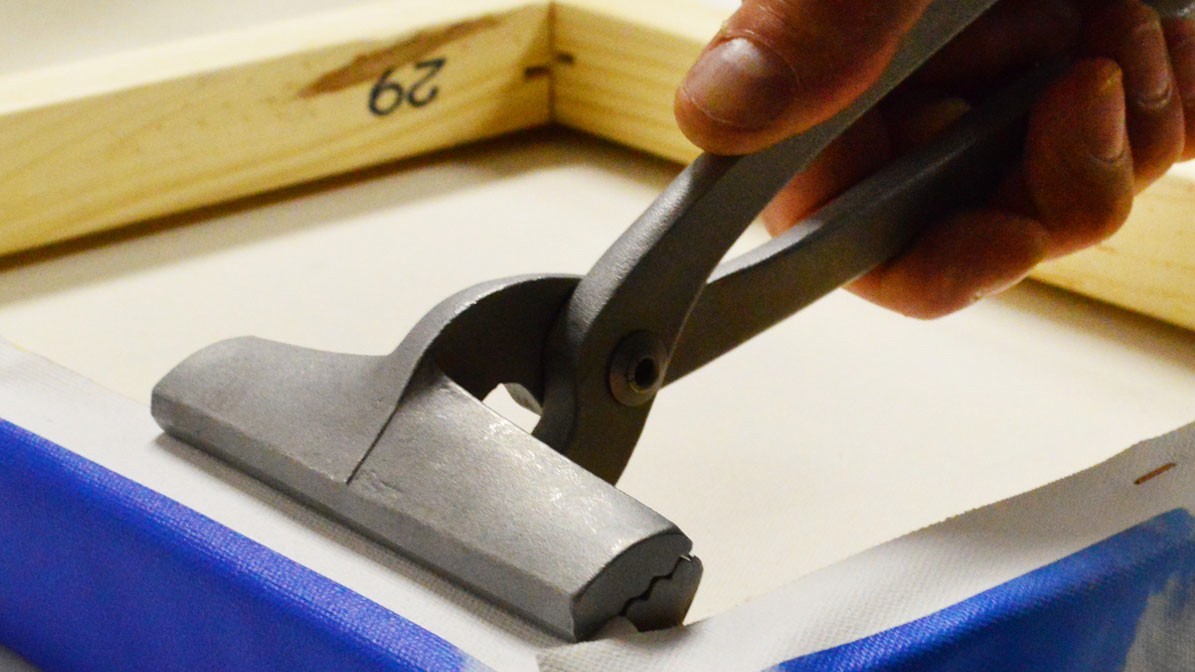Using canvas pliers to stretch canvas
