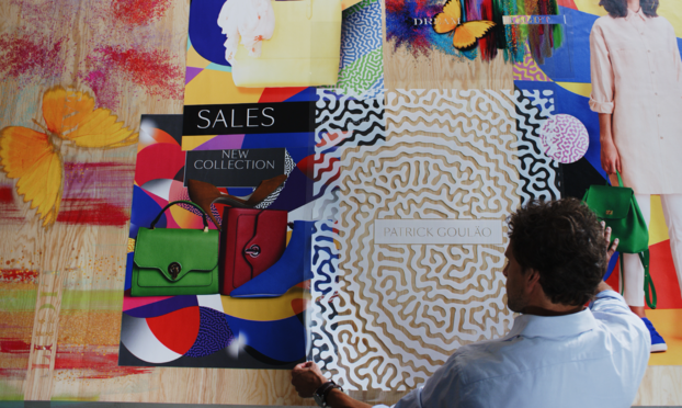 Operator examining prints from an HP Latex printer