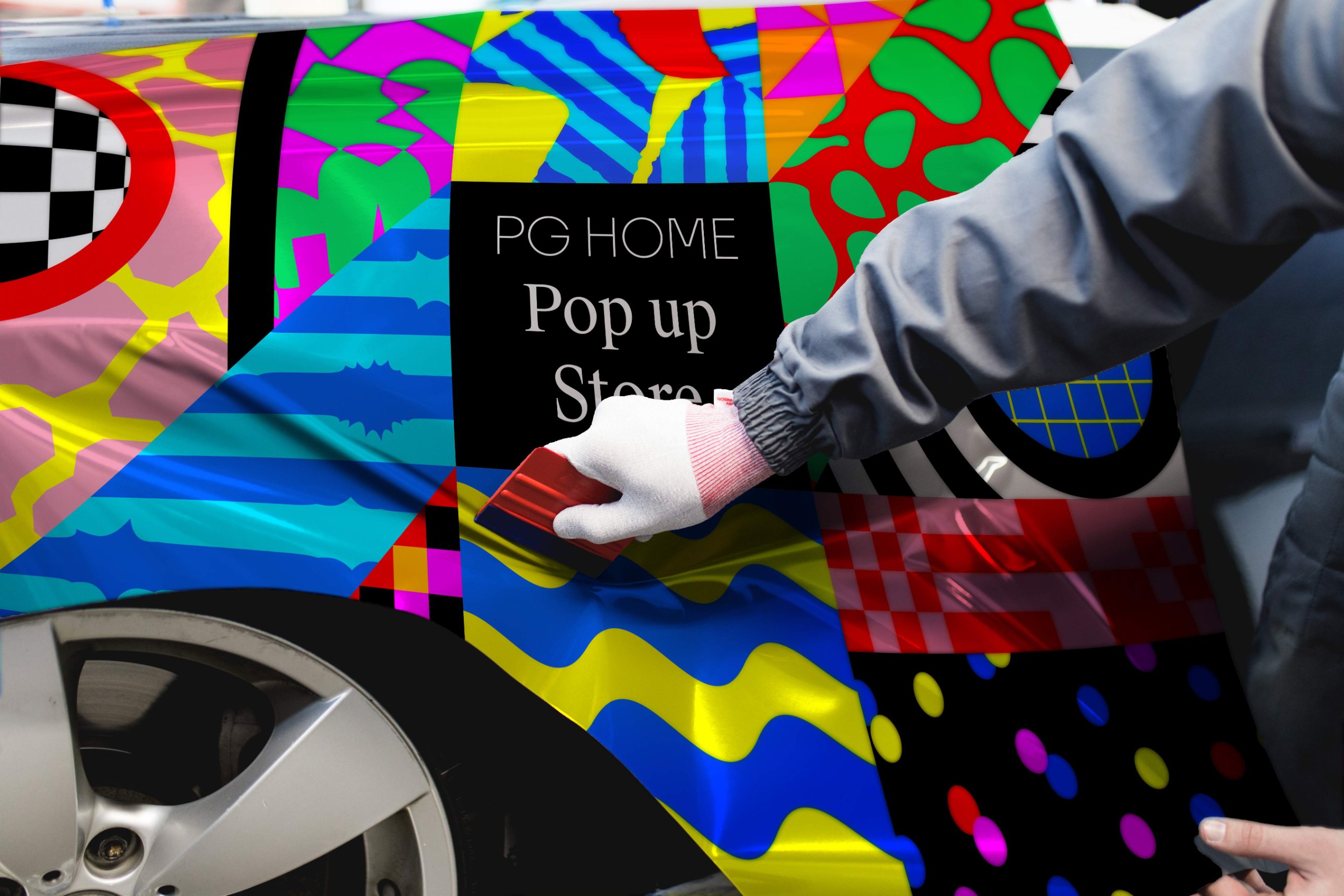 Installer applying a printed vehicle wrap with a squeegee