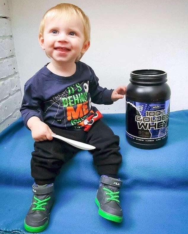 Baby taking and trying out Maxler golden whey.JPG