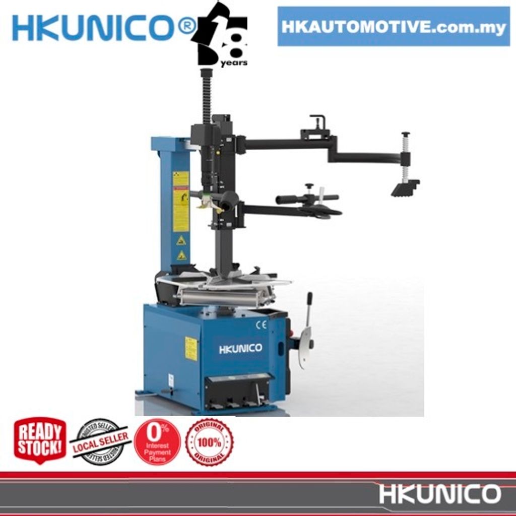 HKUNICO H522AA 22-inch Automatic Tyre Changer with Helper Arm operating in a tyre shop