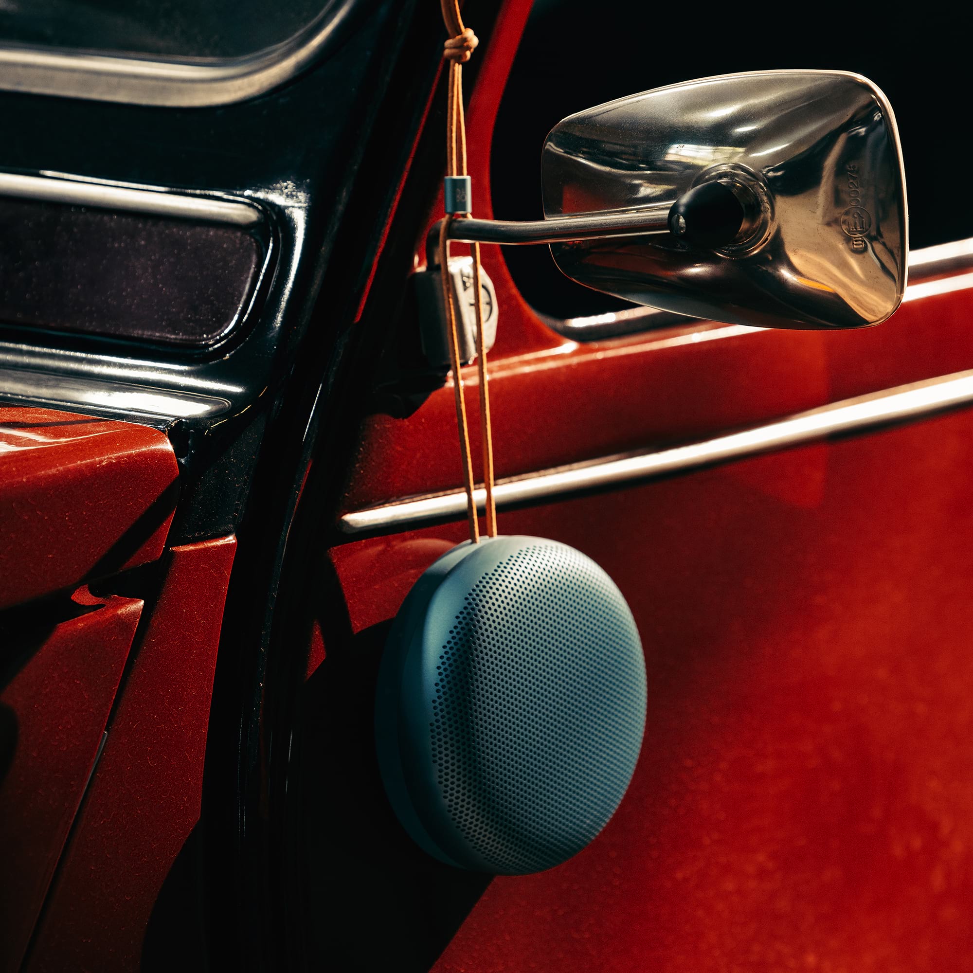 Beautyshot-Beosound-A1-3rd-Gen-red-car-s2000x2000px