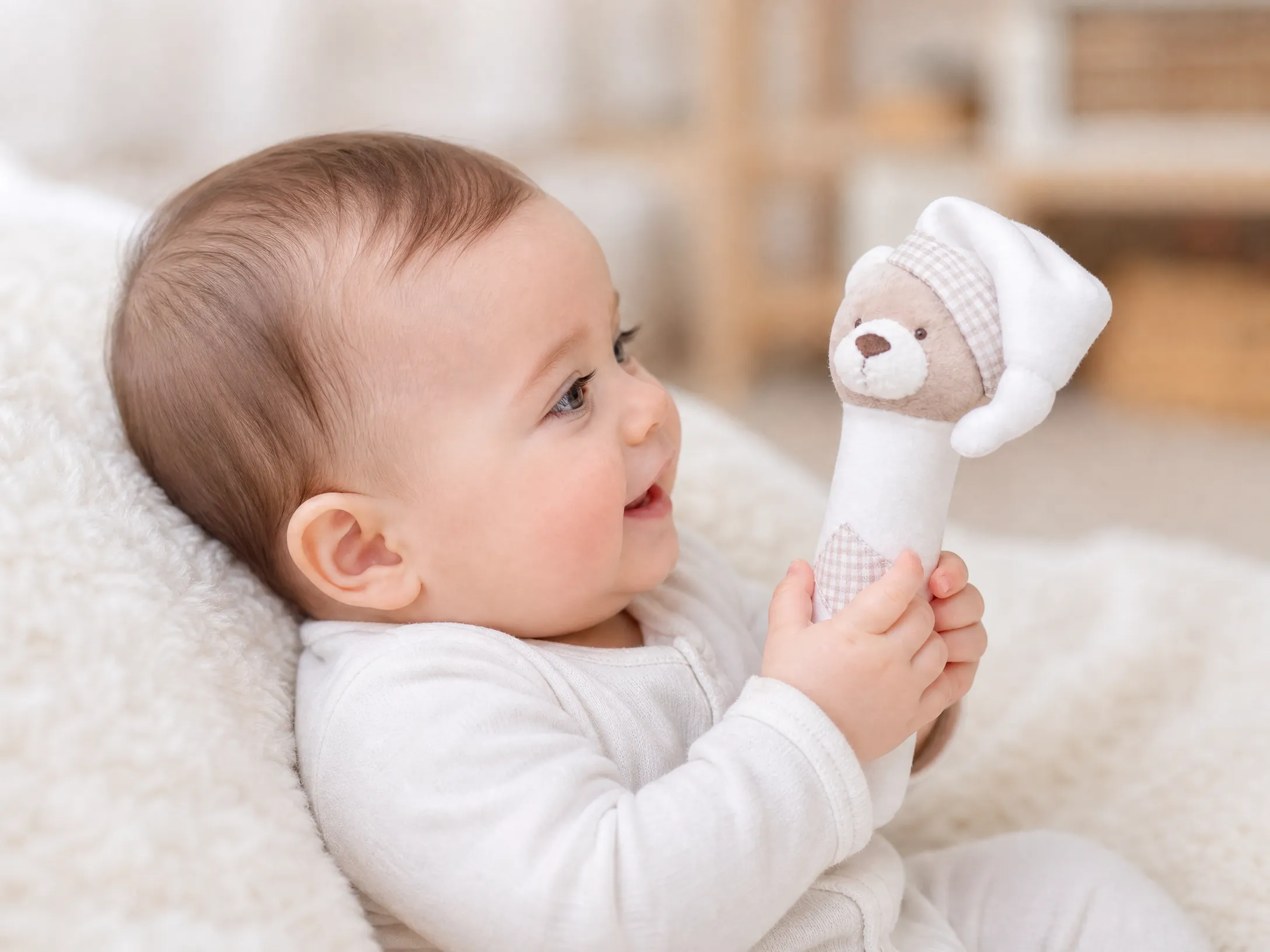 baby_with_rattle_side_view