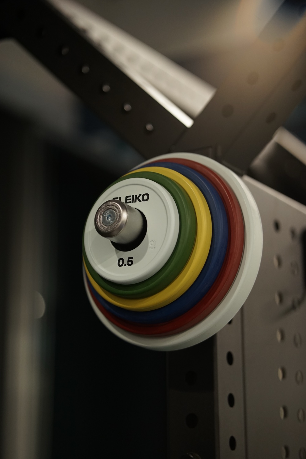Eleiko change plates on a storage peg