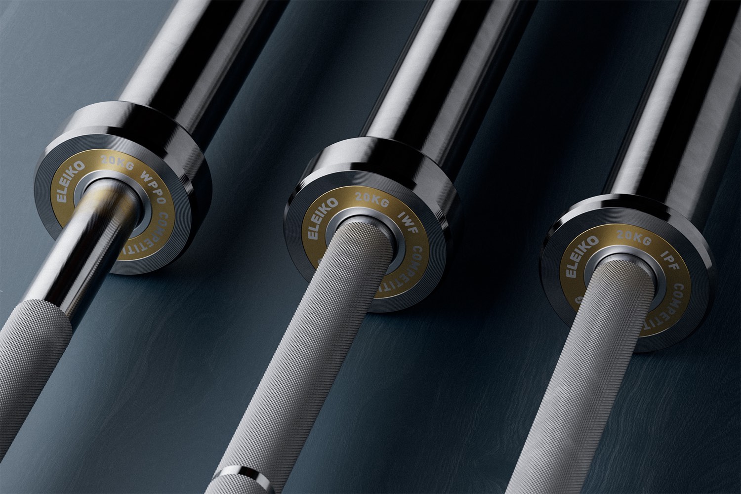 Three Eleiko barbells with gold end caps