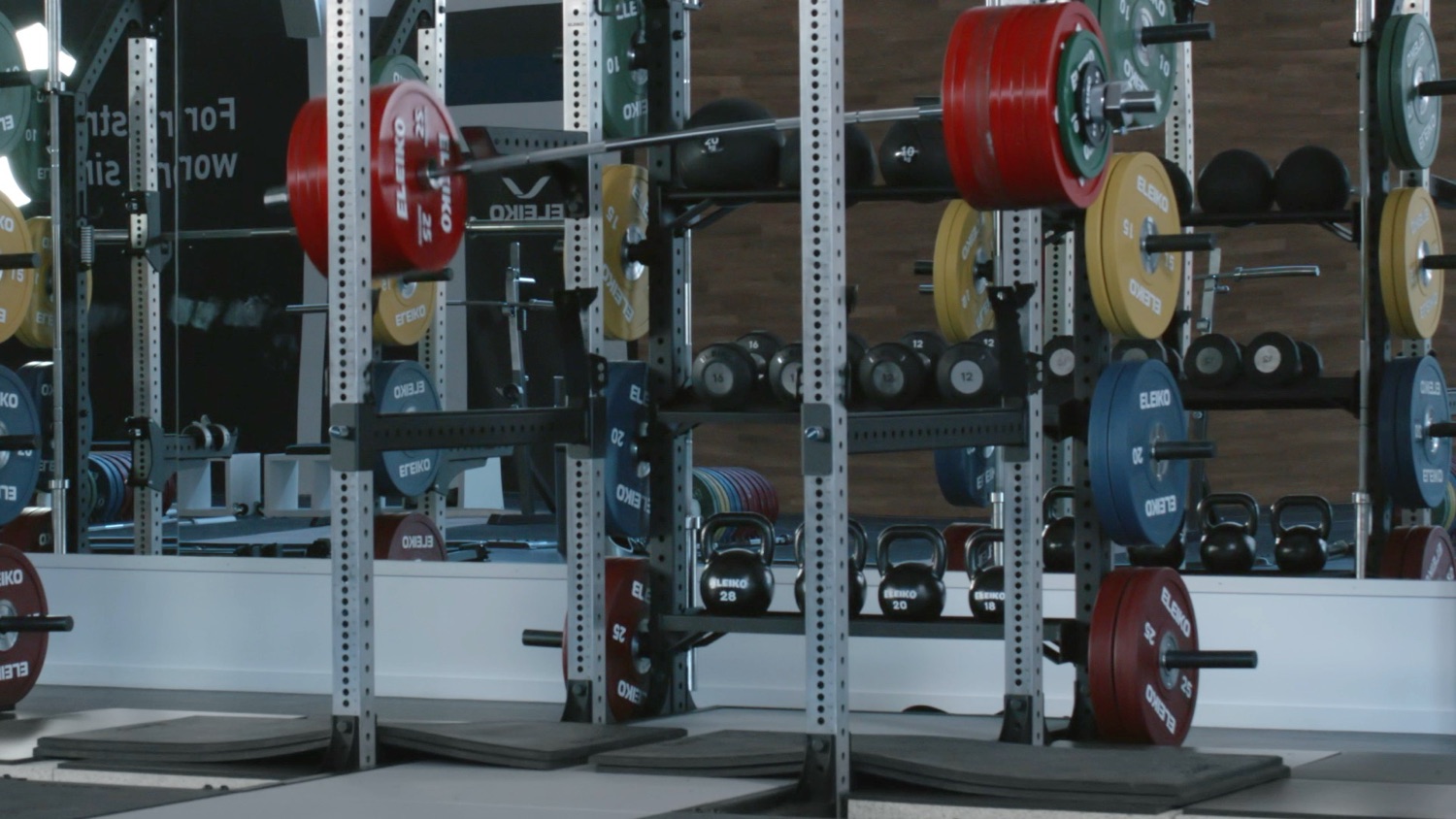 A heavily loaded Eleiko bar flexing as it settles on a rack