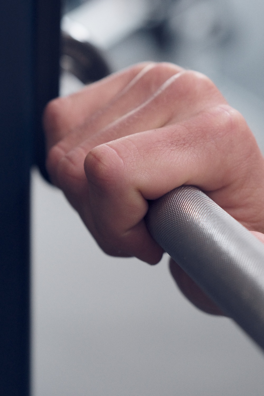 A hand gripping the knurling of an Eleiko bar