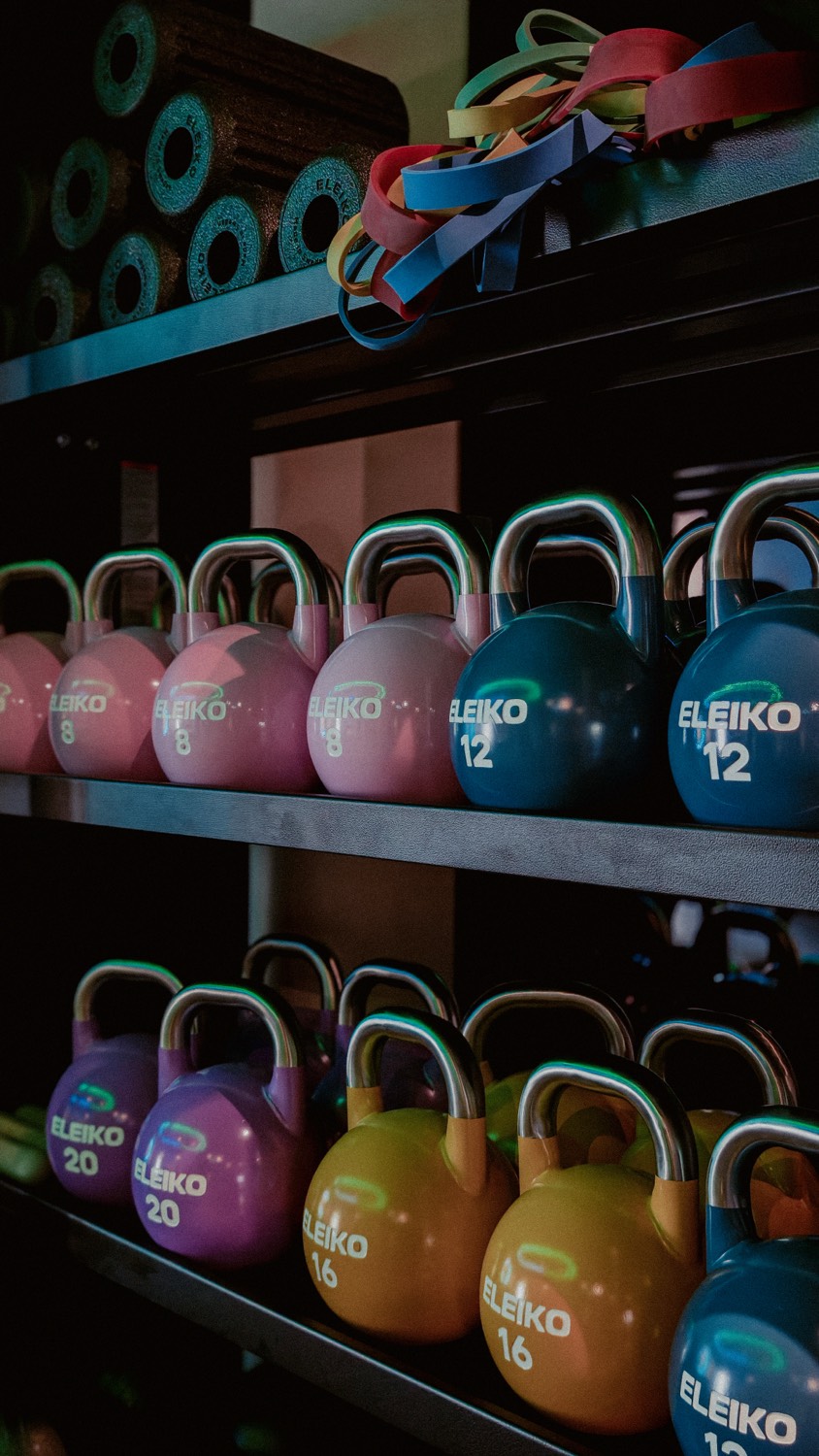 Colour-coded Eleiko kettlebells on shelves at Crater by KLGCC