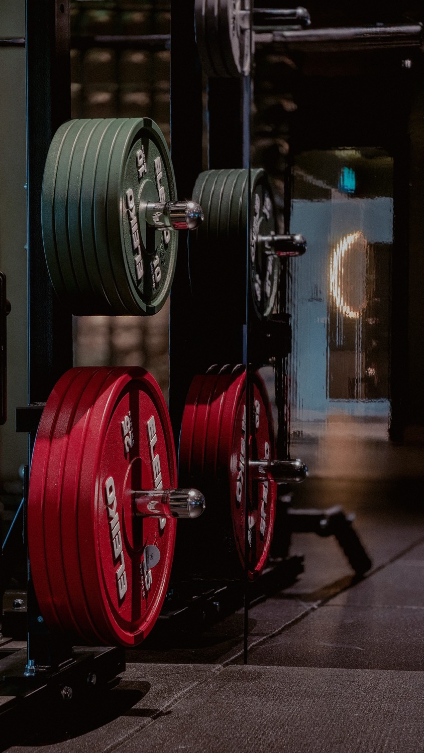 Red and green Eleiko plates on a rack at Crater by KLGCC