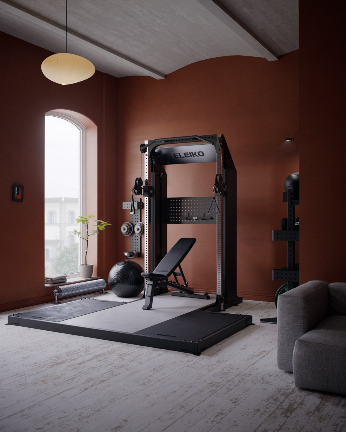 A terracotta home gym with an Eleiko rack and bench by an arched window