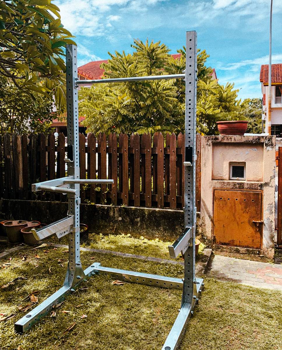 An Eleiko squat stand set up in a garden