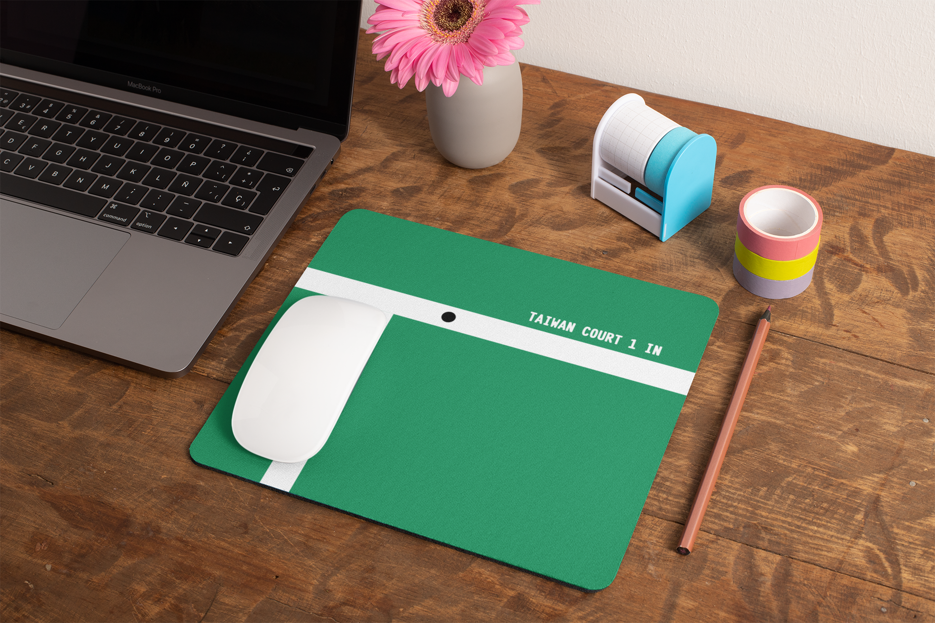 mockup-of-a-mousepad-lying-on-a-rustic-table-next-to-a-flower-vase-27554.png