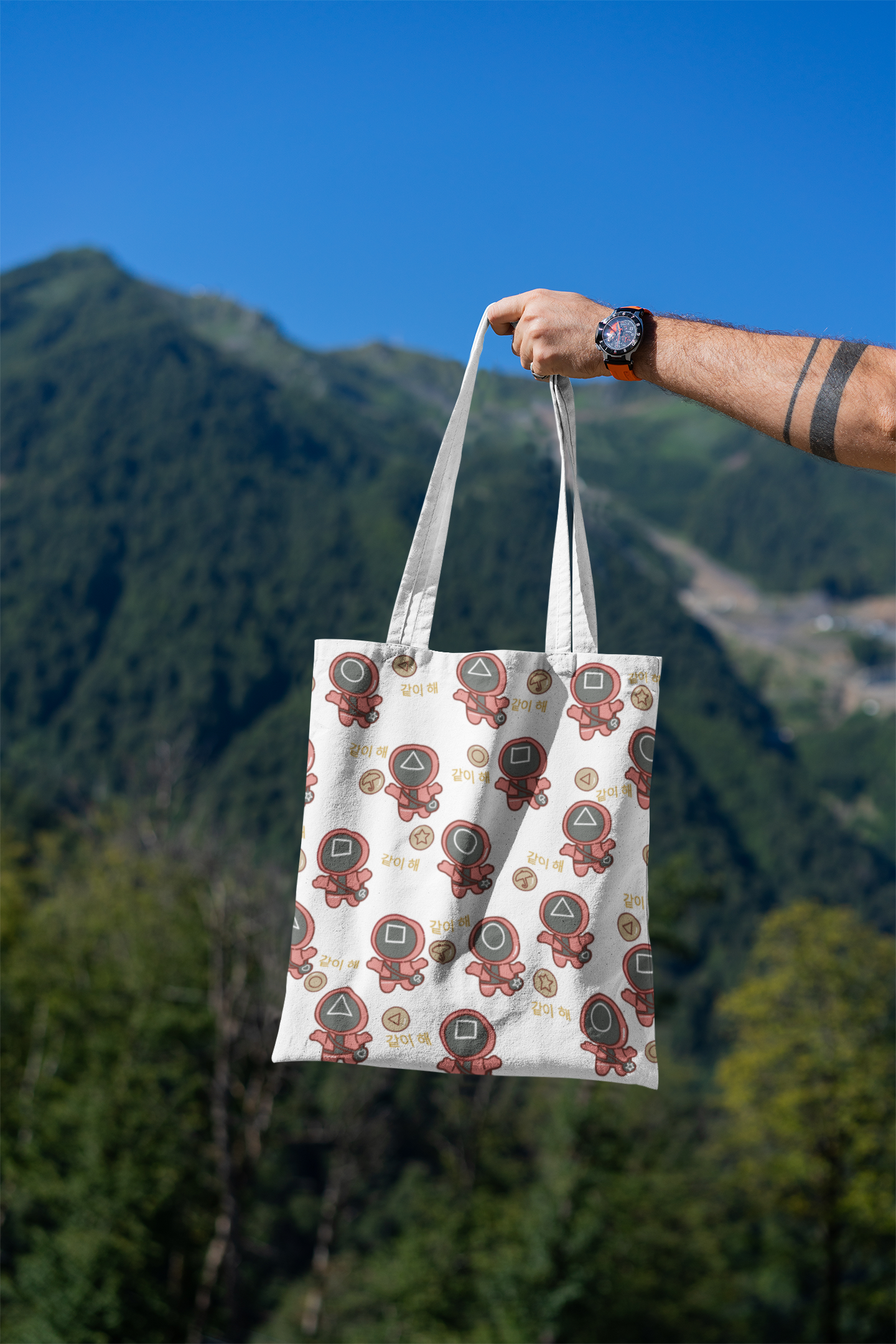 mockup-featuring-a-man-s-hand-holding-a-tote-bag-against-a-natural-scenery-3131-el1 (1).png