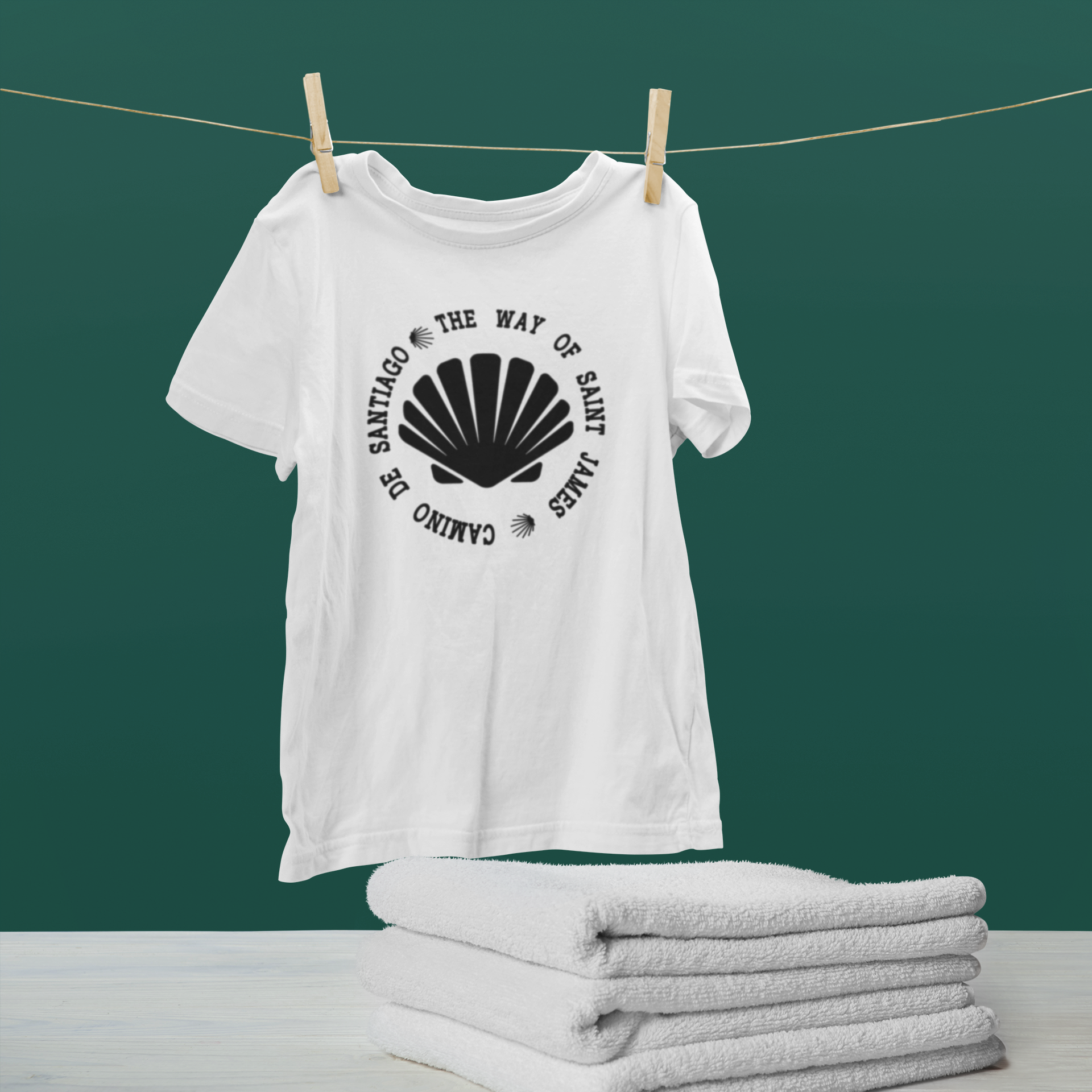 mockup-of-a-hanging-t-shirt-by-some-folded-towels-46150-r-el2 (1)
