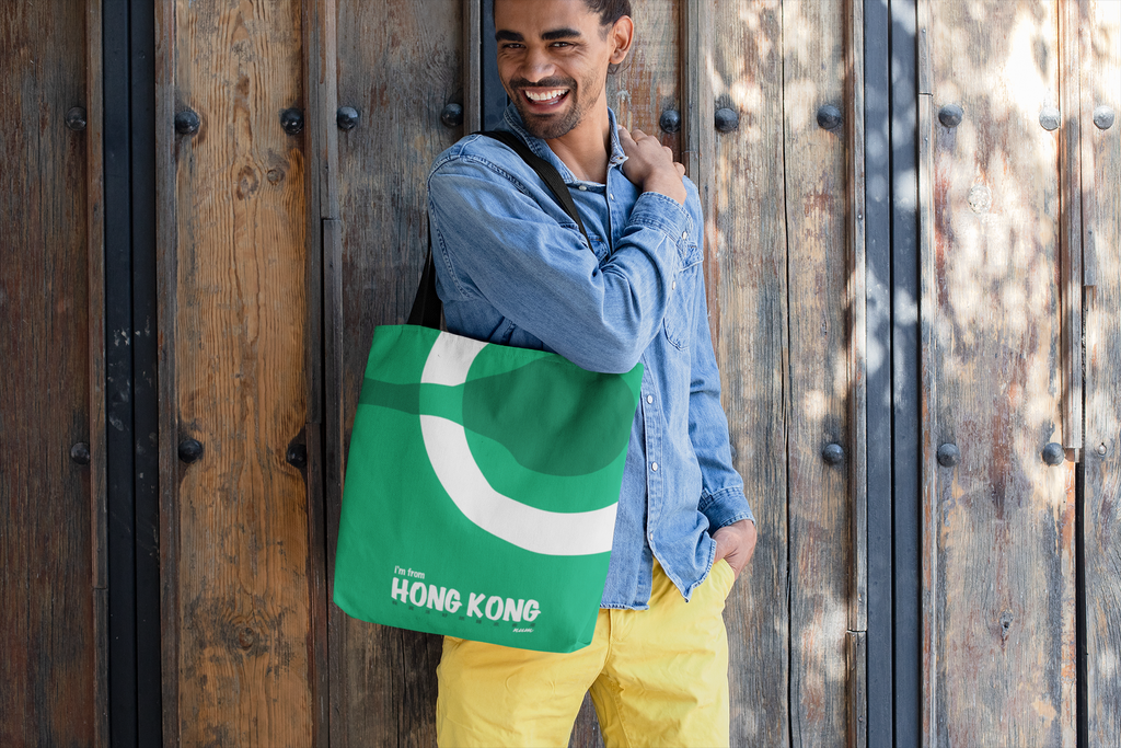 tote-bag-mockup-featuring-a-smiling-man-standing-by-a-wooden-door-26706.png